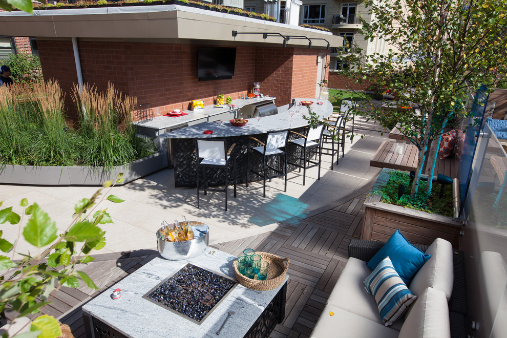 This is an example of a large contemporary roof terrace in Chicago with a fire feature and no cover.