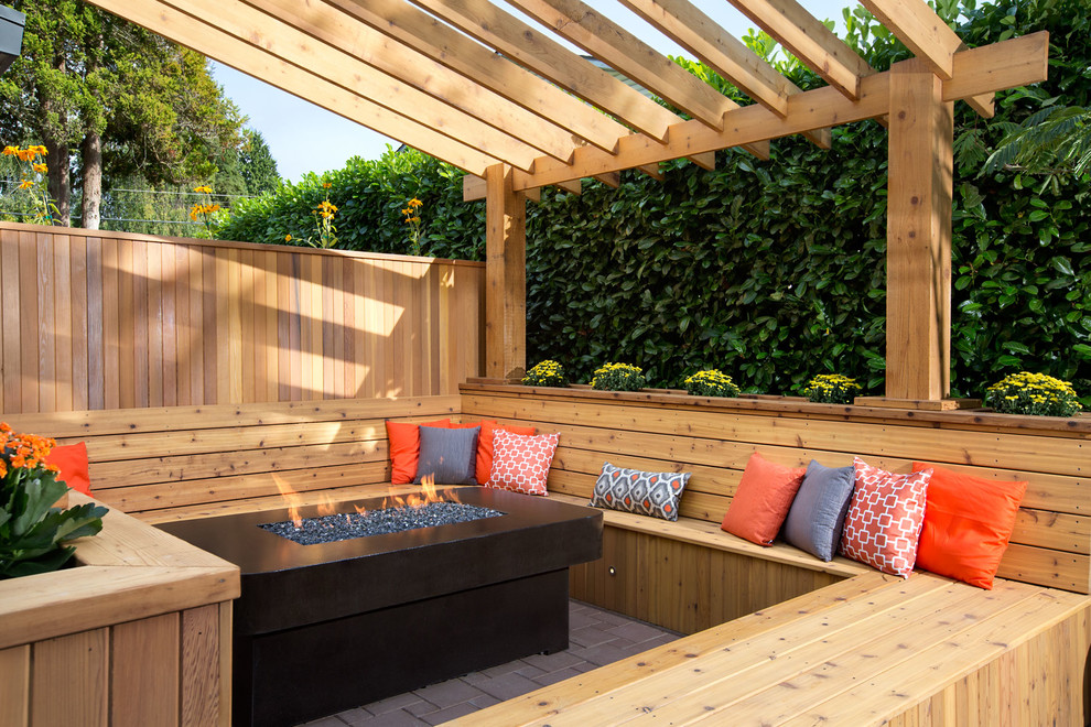 Inspiration for a retro back terrace in Vancouver with a pergola.