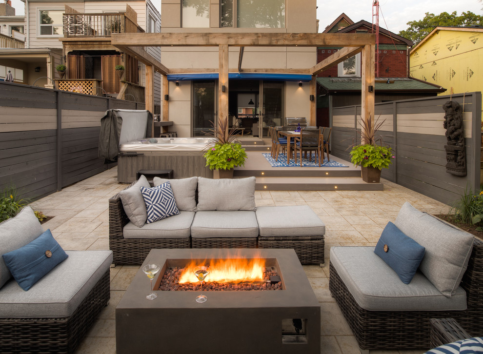 Example of a mid-sized minimalist backyard patio design in Toronto with an awning