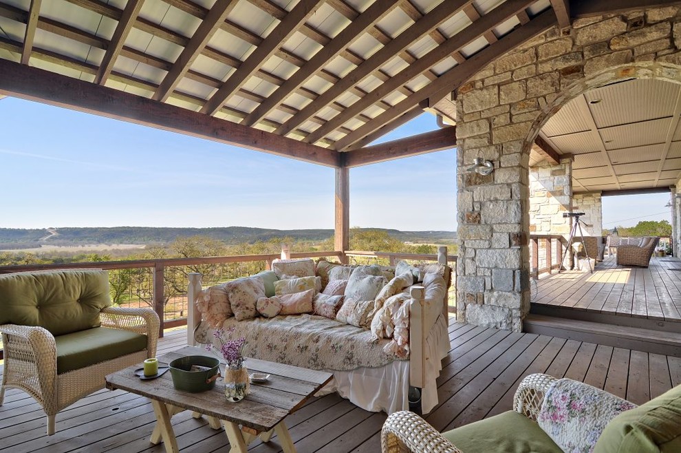 Inspiration for a huge cottage backyard deck remodel in Austin with a roof extension