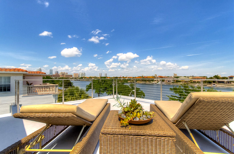 Example of a large minimalist rooftop deck design in Tampa with no cover