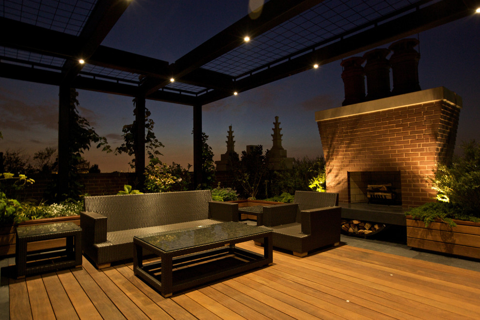 Mid-sized minimalist rooftop deck photo in Chicago with a fire pit and a pergola
