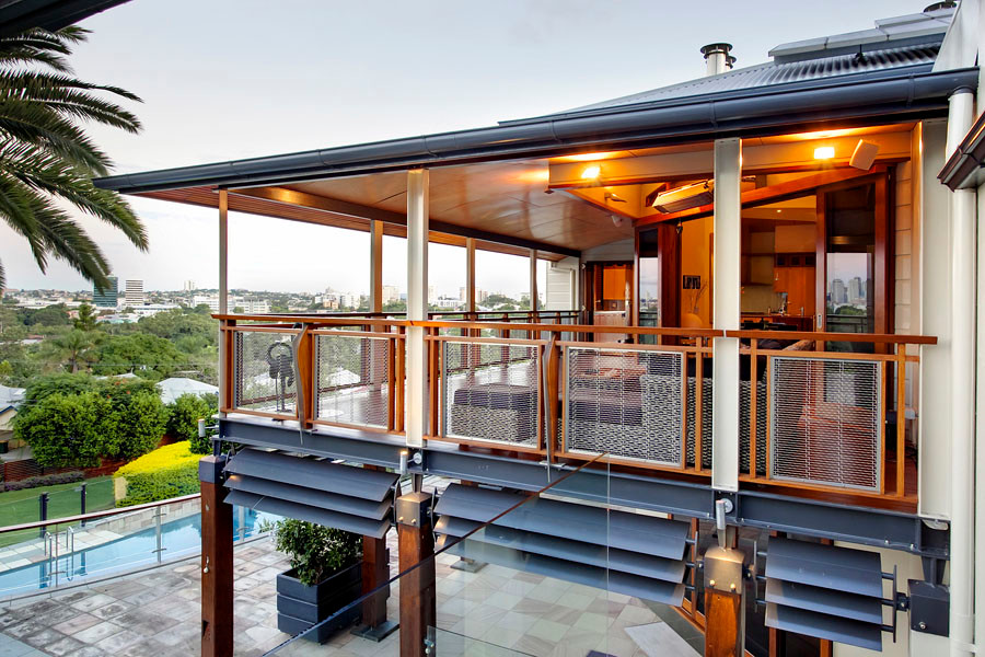 Expansive traditional back terrace in Brisbane with a roof extension.