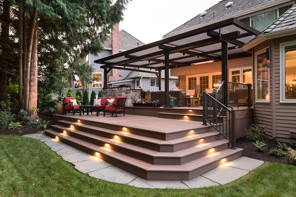 Large transitional backyard outdoor kitchen deck photo in Seattle with a pergola