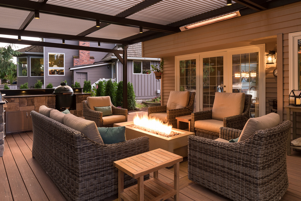 Large transitional backyard outdoor kitchen deck photo in Seattle with a pergola