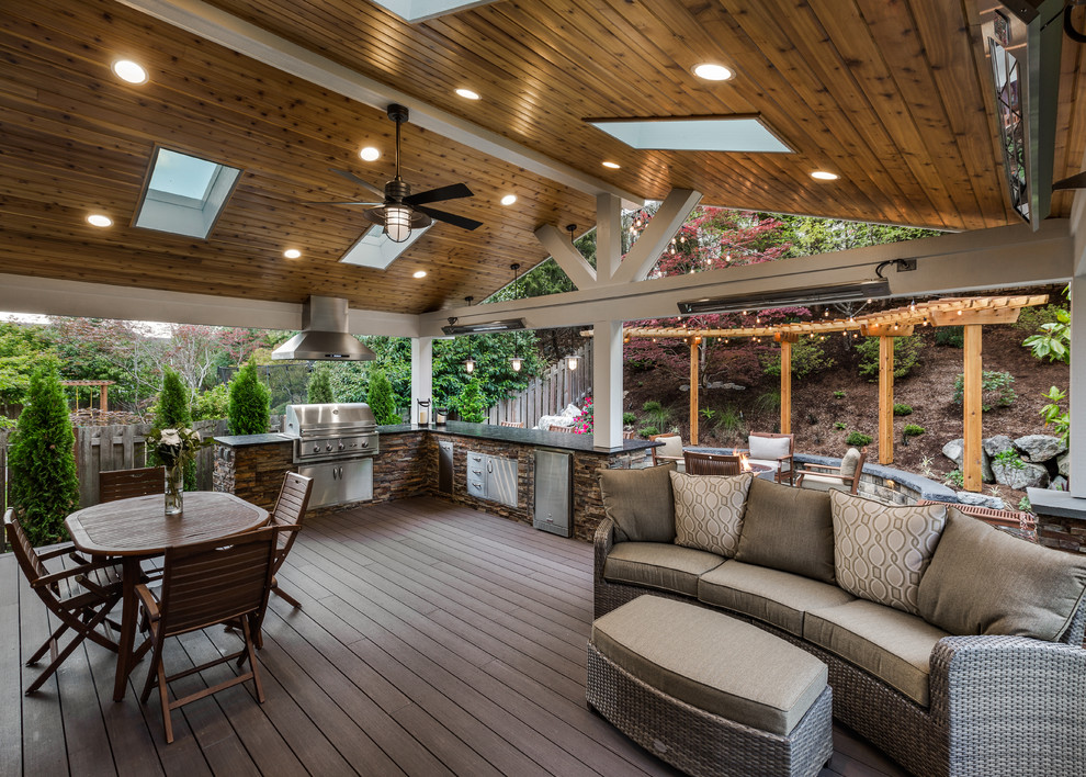 Outdoor kitchen deck - large transitional backyard outdoor kitchen deck idea in Seattle with a roof extension