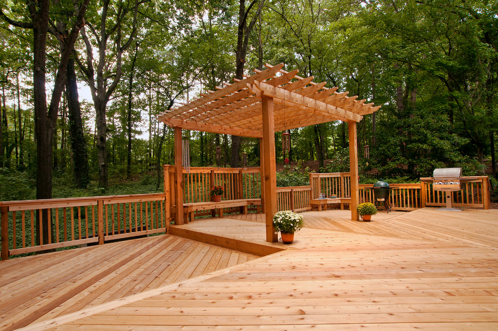 Example of a large classic backyard outdoor kitchen deck design in Atlanta with a pergola