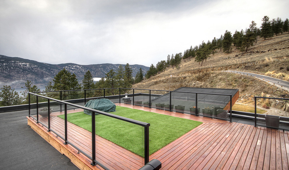 This is an example of an expansive modern roof terrace in Vancouver with a fire feature.