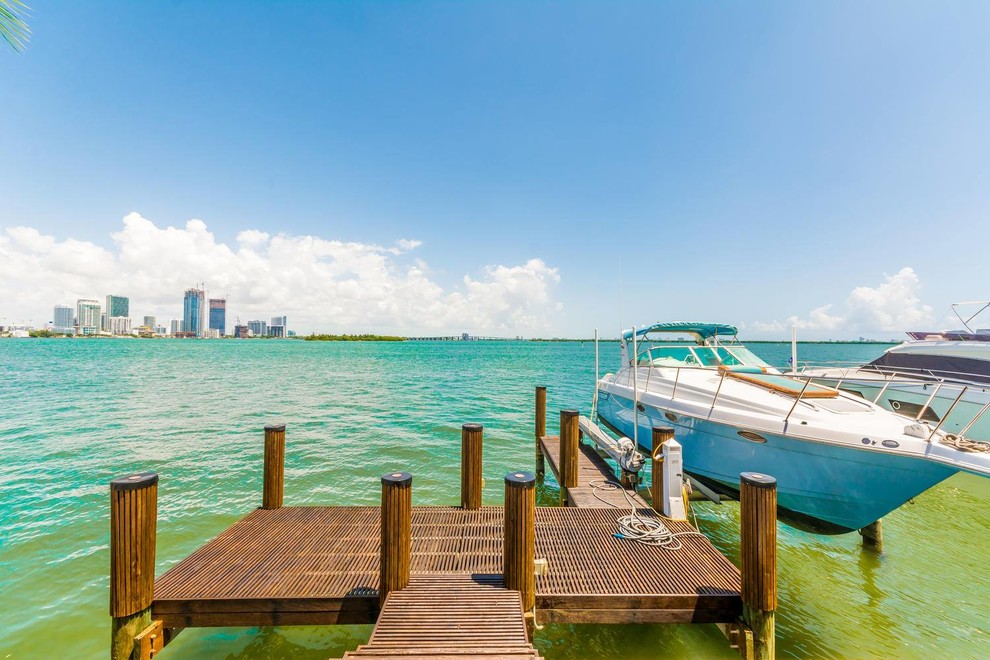 Medium sized classic back terrace in Miami with a dock and no cover.