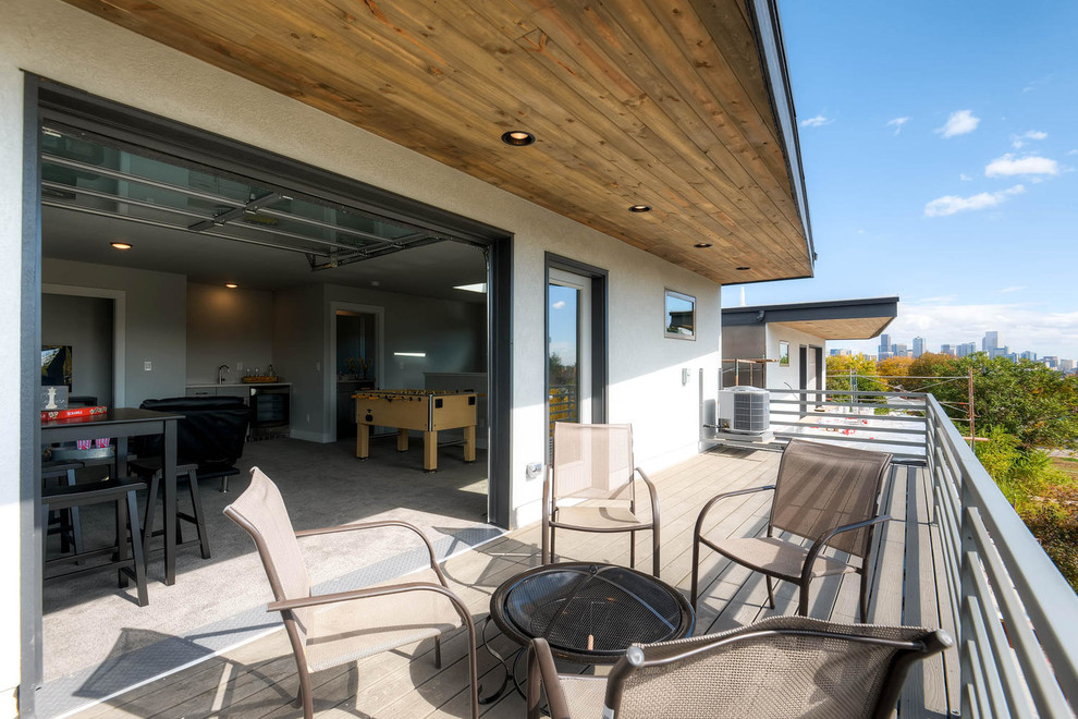 Photo of a large contemporary roof terrace in Denver with a roof extension and a fire feature.