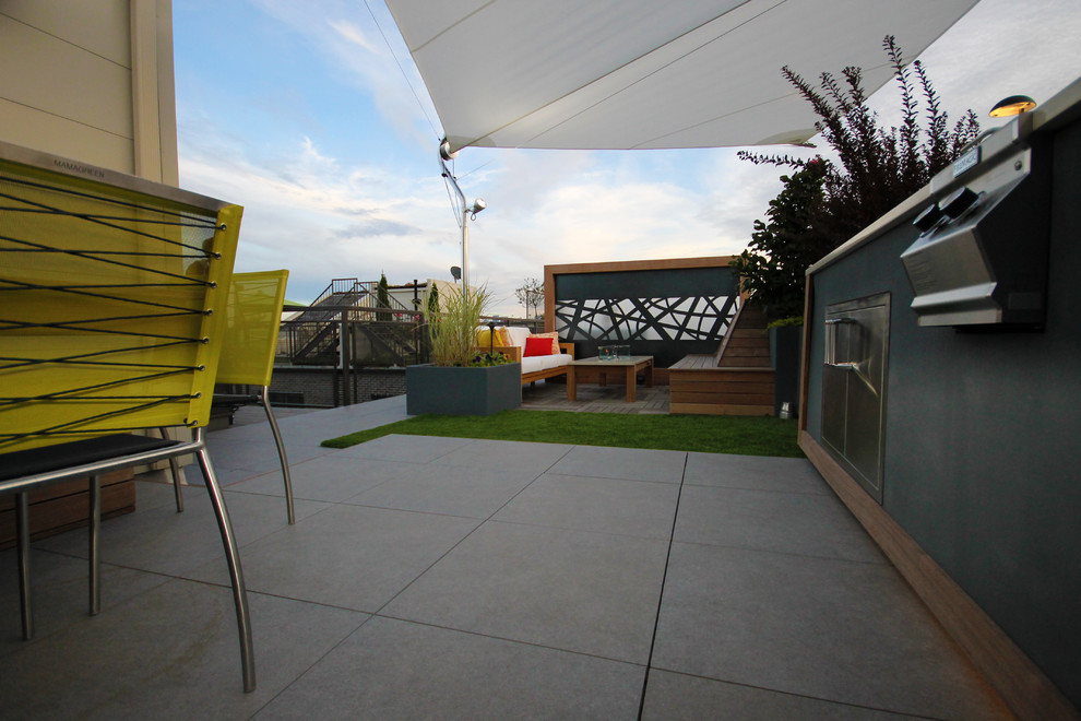 Inspiration for a small modern roof terrace in Chicago with an outdoor kitchen and an awning.