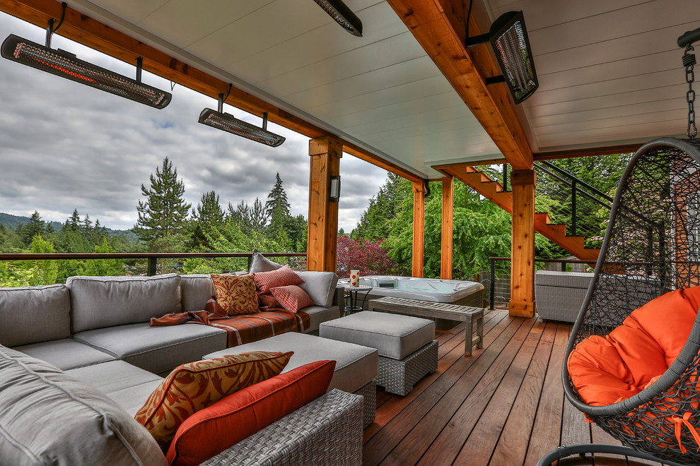 This is an example of a large modern back terrace in Seattle with a roof extension.