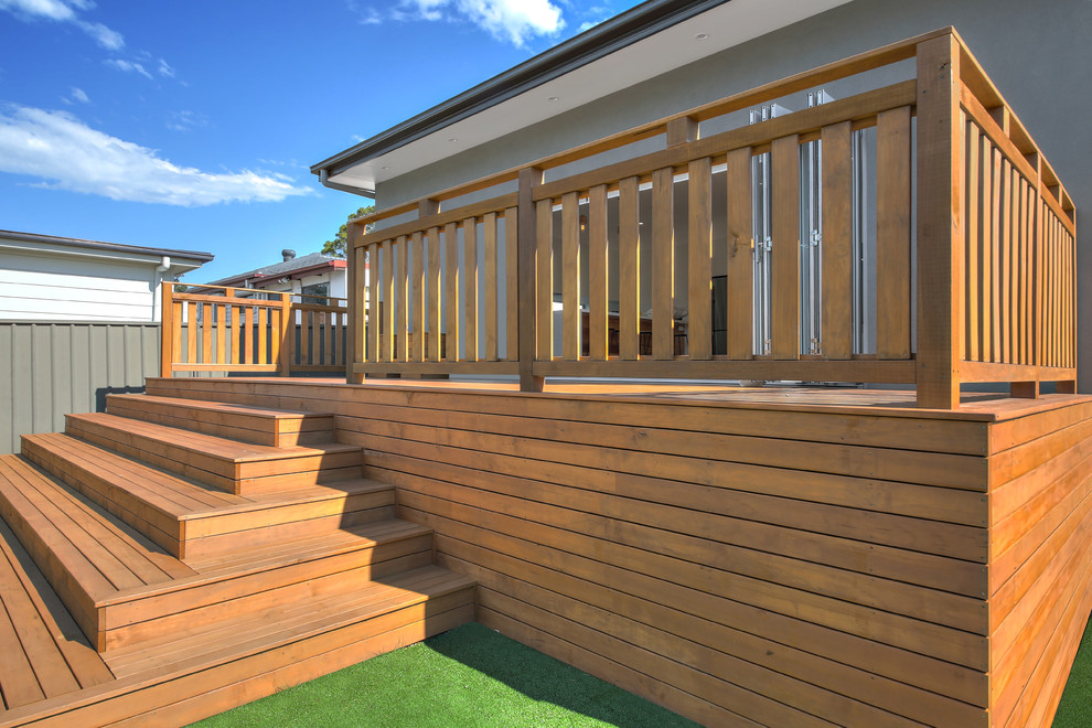 Deck - large modern backyard deck idea in Sydney with no cover