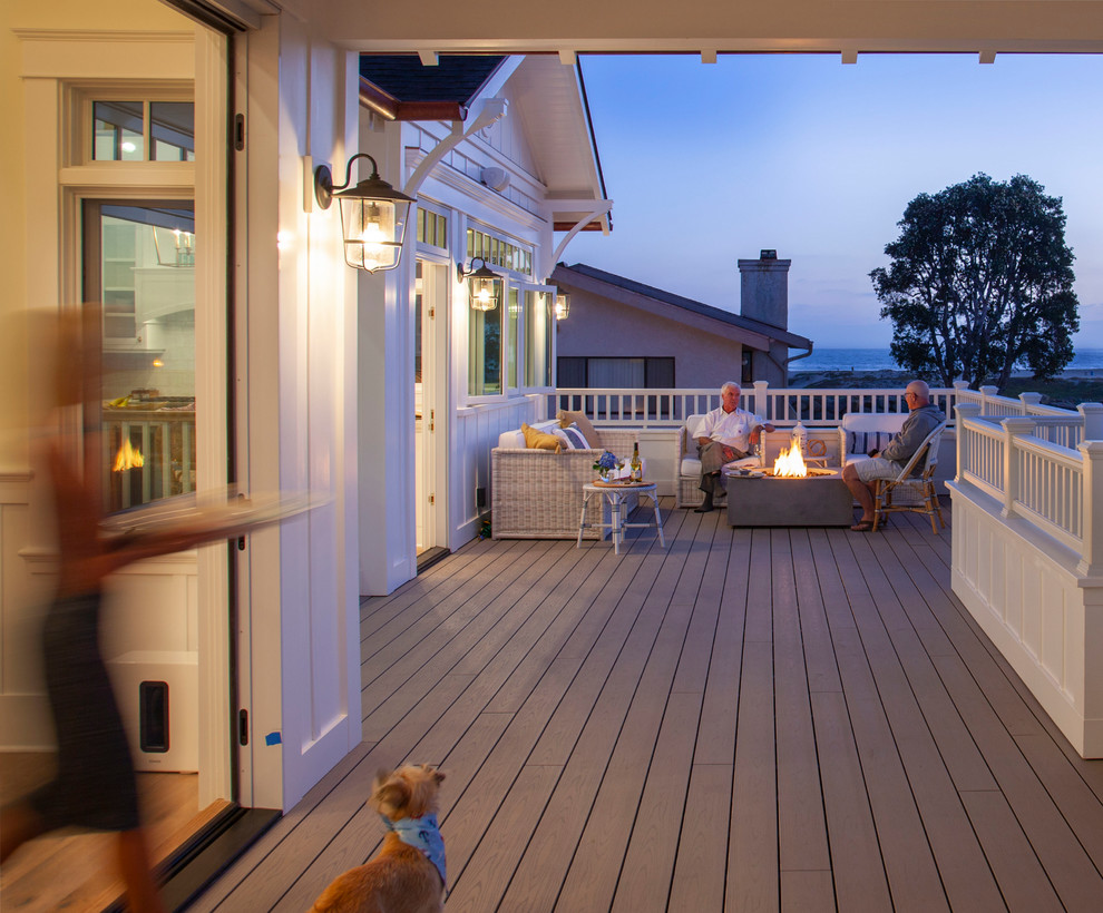 Deck - large coastal side yard deck idea in San Diego with a fire pit and a roof extension