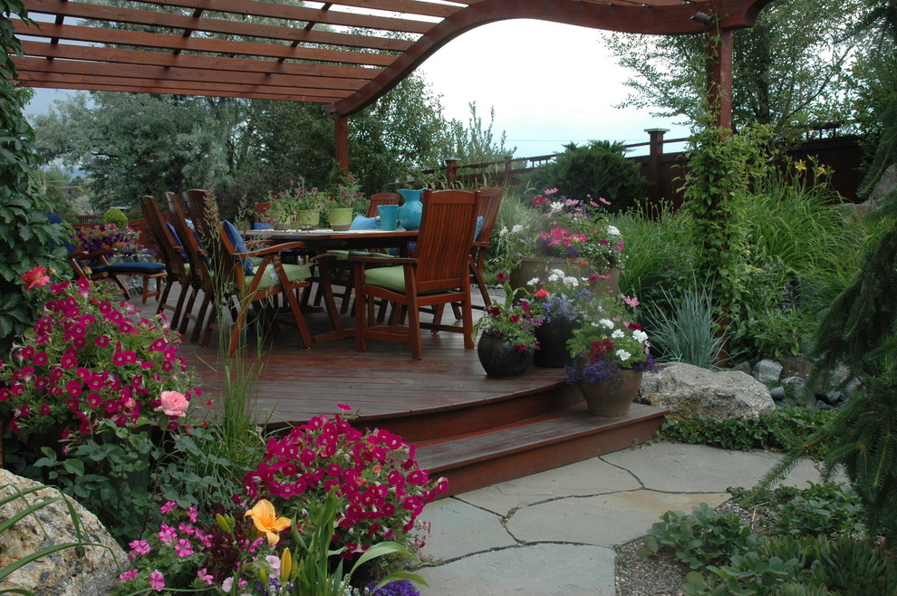 Deck - large traditional backyard deck idea in Denver with a pergola