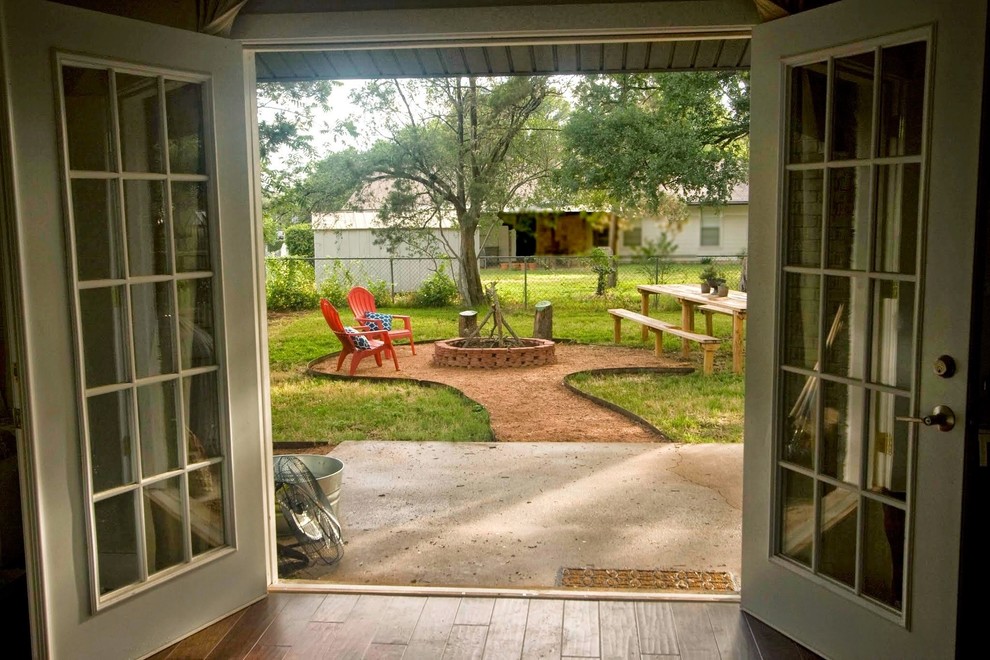 Medium sized country back terrace in Austin with no cover.
