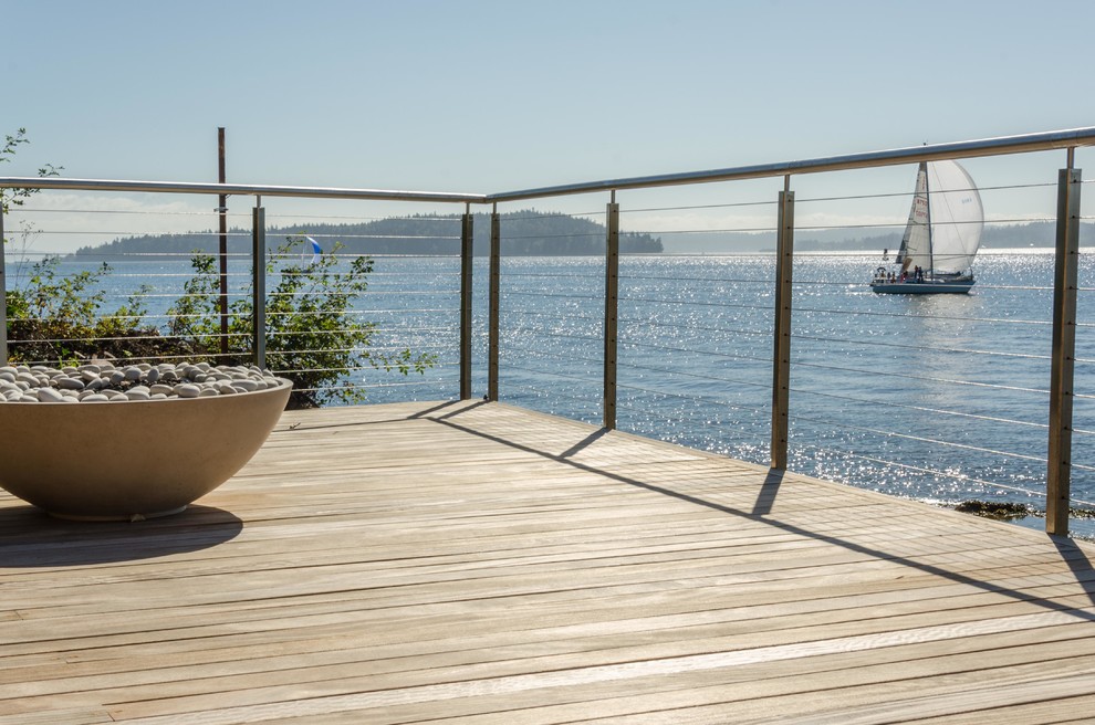 Inspiration for a mid-sized coastal backyard water fountain deck remodel in Seattle with no cover