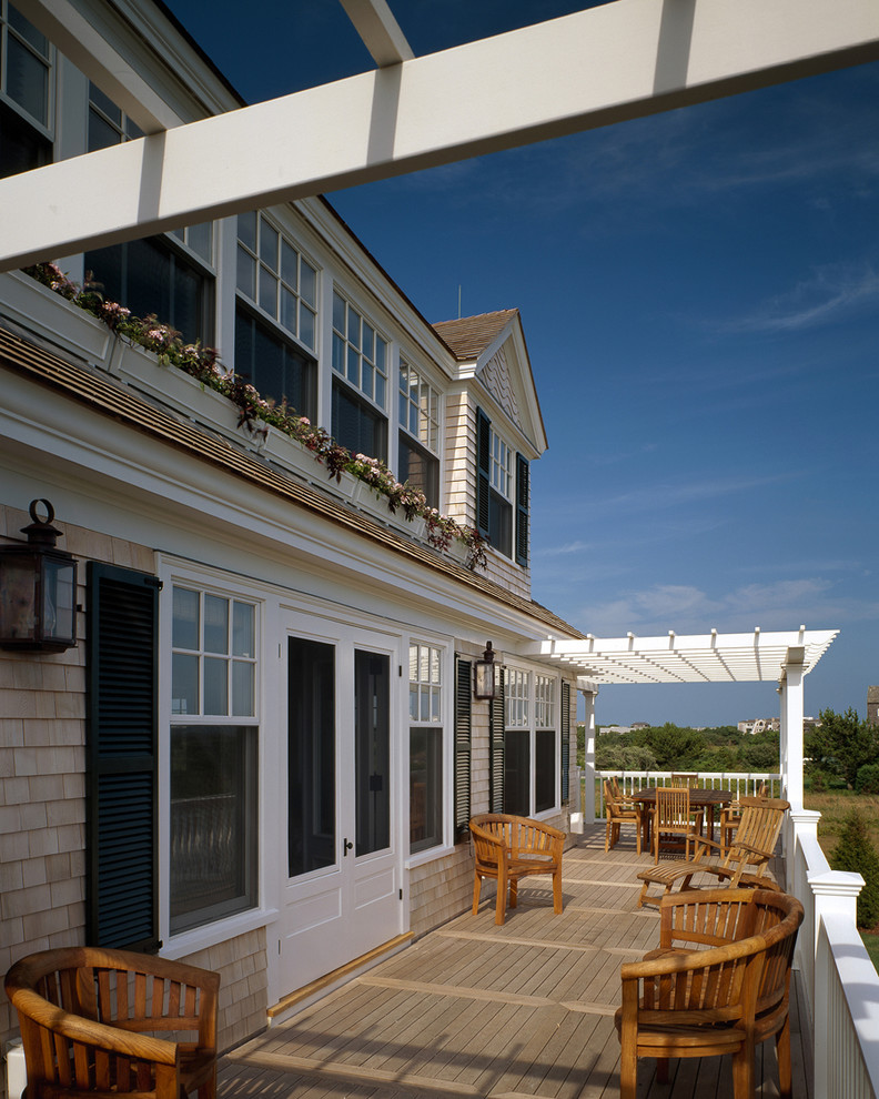 Inspiration for a large nautical back terrace in Boston with a pergola.