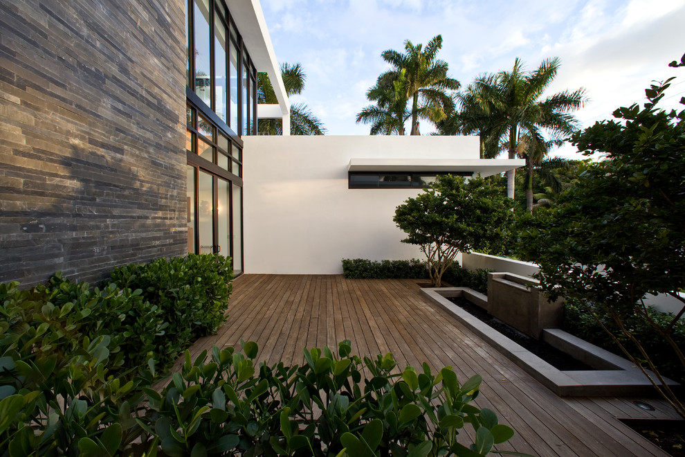 This is an example of a contemporary terrace in Miami with a water feature and no cover.