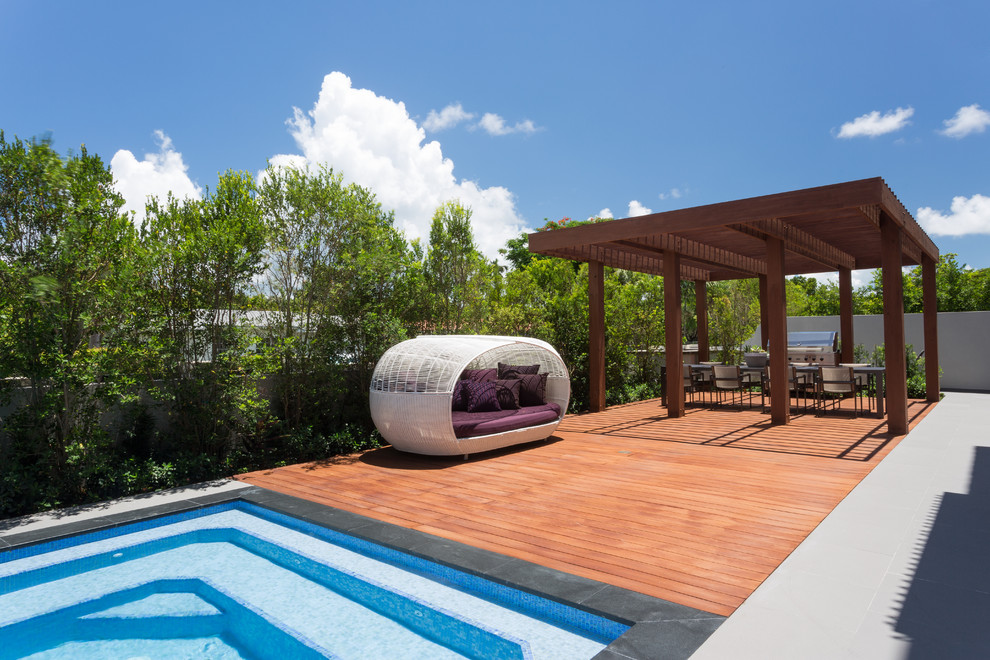 Mid-sized trendy backyard water fountain deck photo in Miami