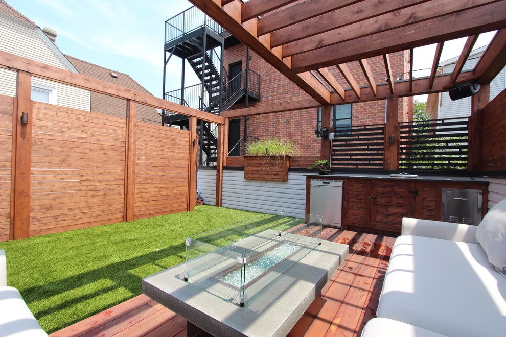 Photo of a medium sized modern roof terrace in Chicago with an outdoor kitchen and a pergola.