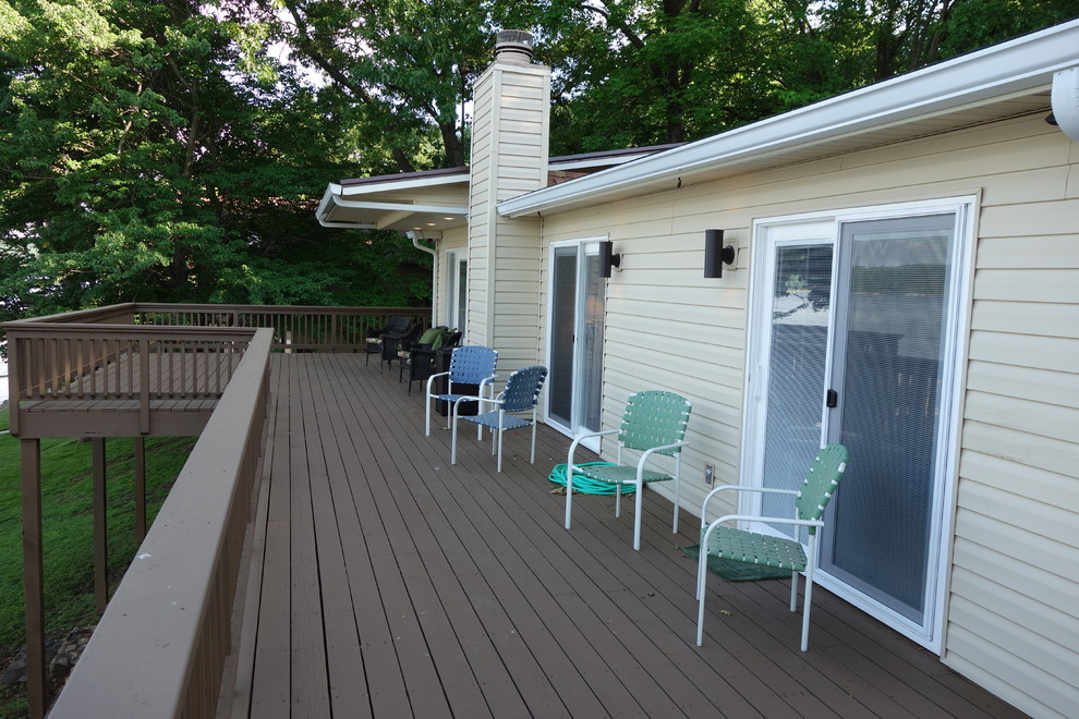 Example of a minimalist deck design in Other with a roof extension