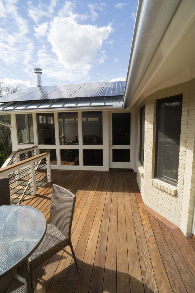 This is an example of a medium sized classic back terrace in Austin with a roof extension.