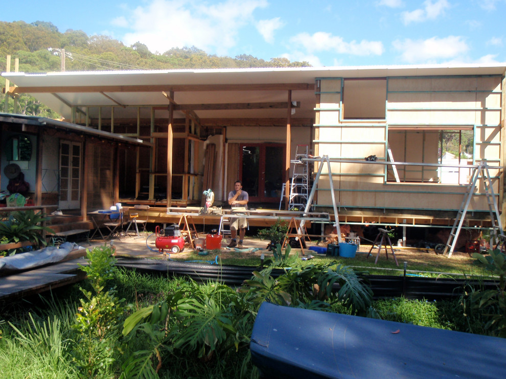 This is an example of a medium sized eclectic back terrace in Central Coast with a roof extension.