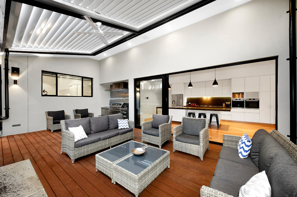 Large trendy side yard outdoor kitchen deck photo in Melbourne with a pergola