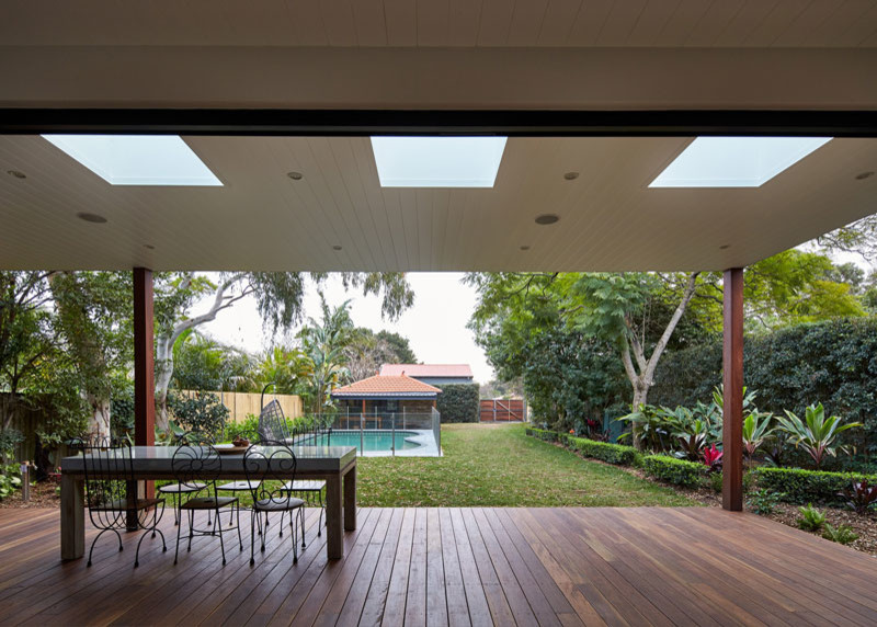 This is an example of a medium sized contemporary back terrace in Sydney with a roof extension.