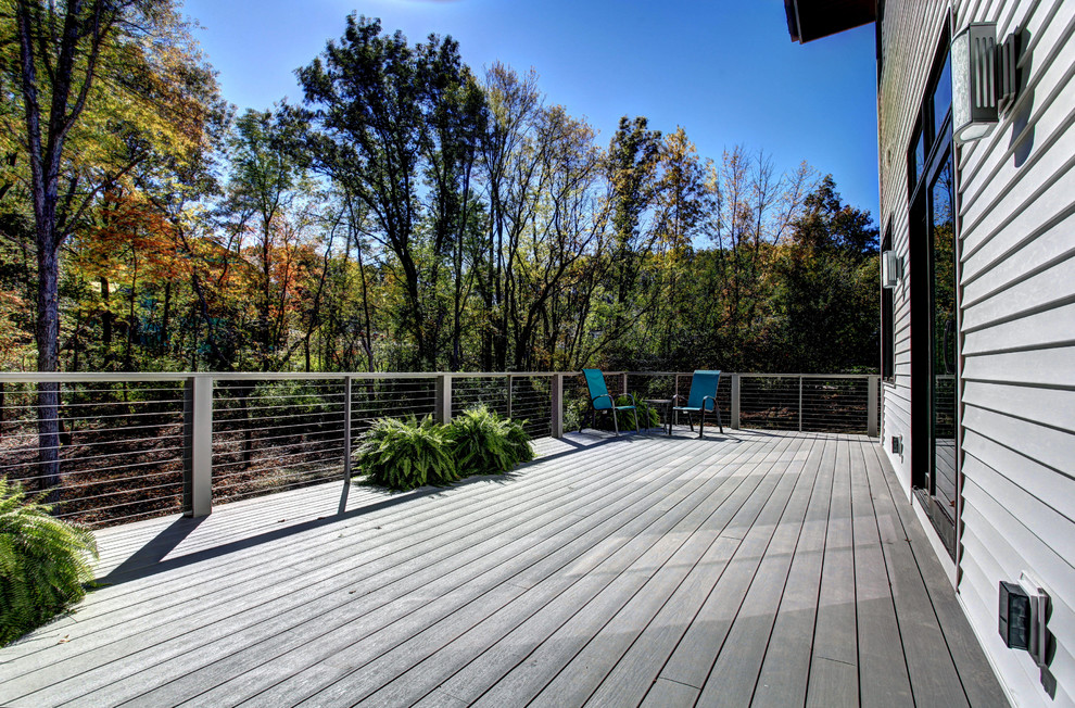 Inspiration for a large contemporary backyard deck remodel in Grand Rapids with no cover