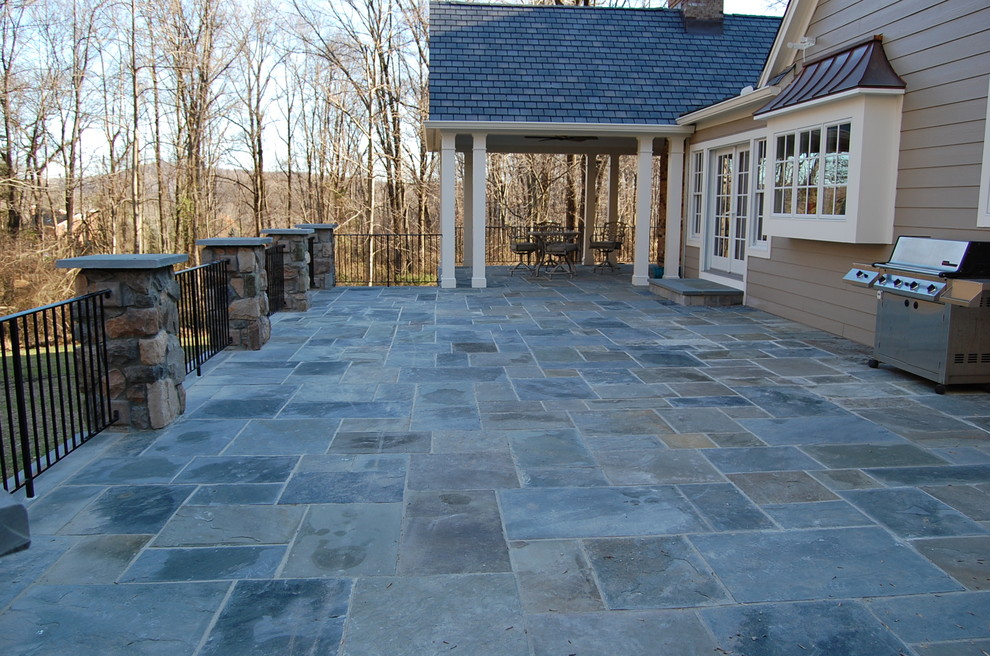 Inspiration for a large timeless backyard deck remodel in New York with a roof extension