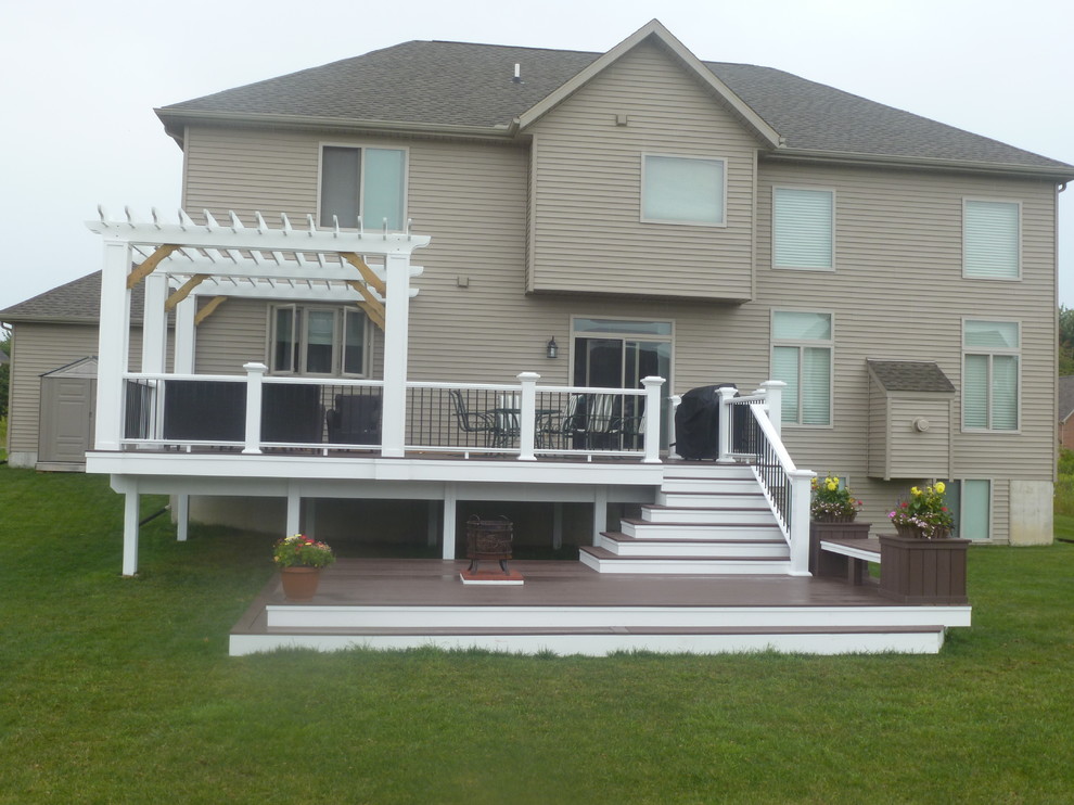 Example of a large classic backyard deck design in Detroit with a pergola