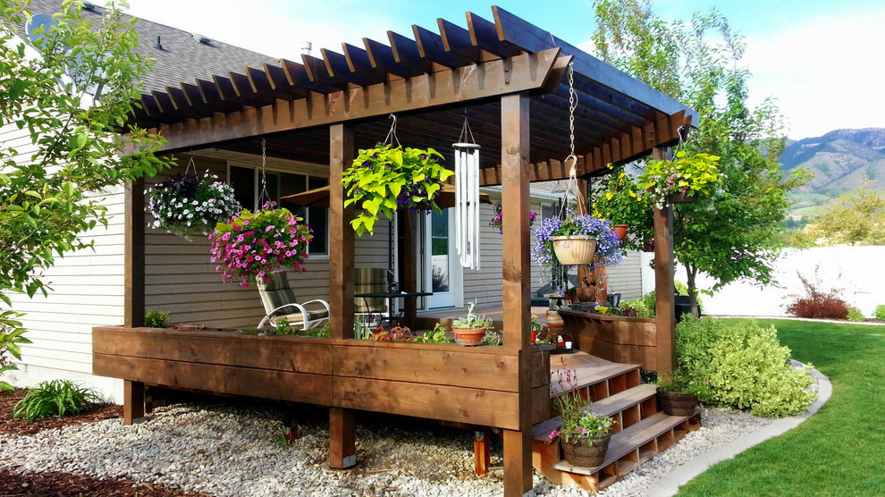 Inspiration for a mid-sized timeless backyard deck container garden remodel in Salt Lake City with a pergola