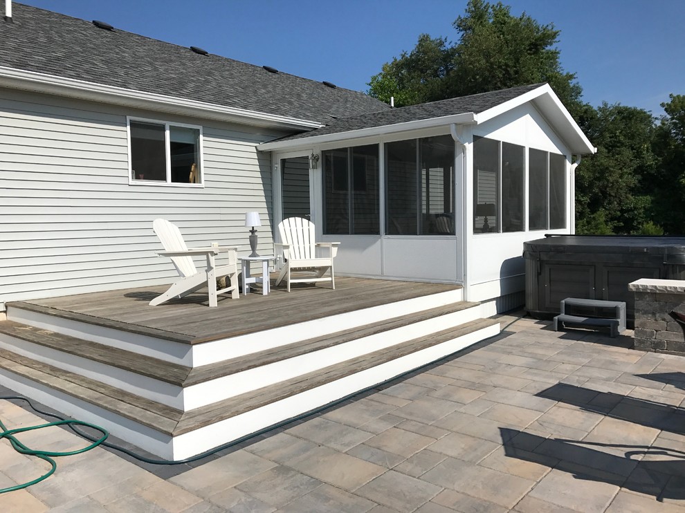 This is an example of a small nautical back terrace in Grand Rapids with no cover.