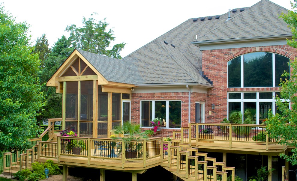 Inspiration for a large timeless backyard deck remodel in Louisville with a roof extension