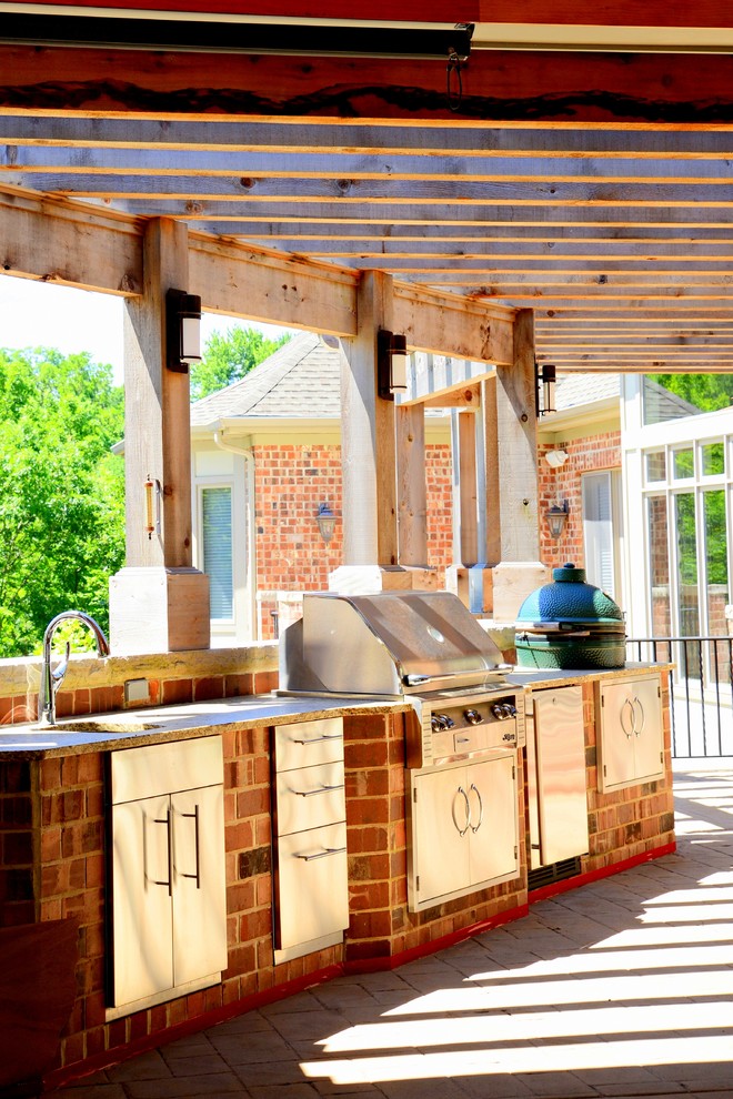 Outdoor kitchen deck - traditional backyard outdoor kitchen deck idea in St Louis with a pergola
