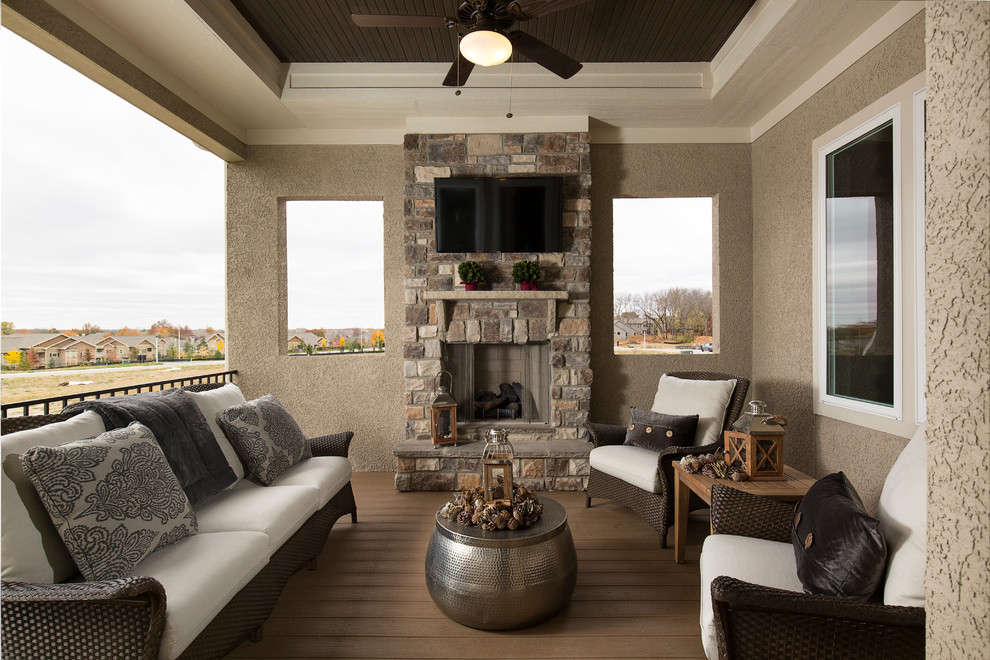 Inspiration for a classic terrace in Kansas City with a fireplace and a roof extension.
