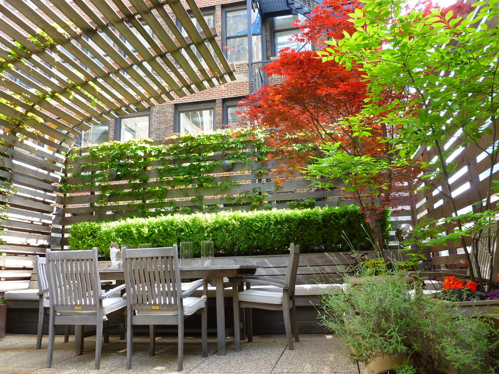 This is an example of a large modern roof terrace in New York with a living wall.