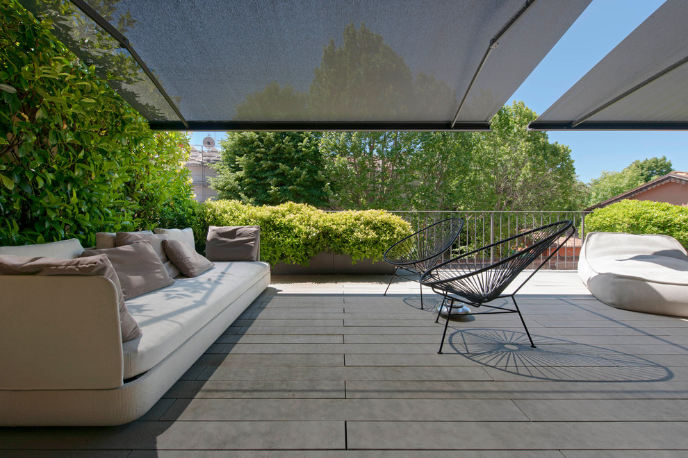 Inspiration for a huge modern rooftop rooftop deck remodel in Bologna with an awning