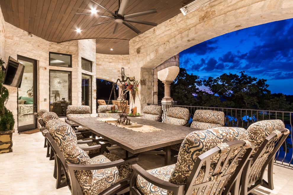Inspiration for an expansive mediterranean back terrace in Austin with an outdoor kitchen and a roof extension.