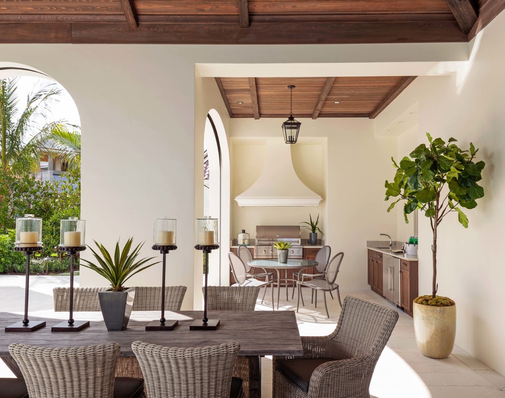 Inspiration for an expansive world-inspired back terrace in Miami with an outdoor kitchen and a roof extension.