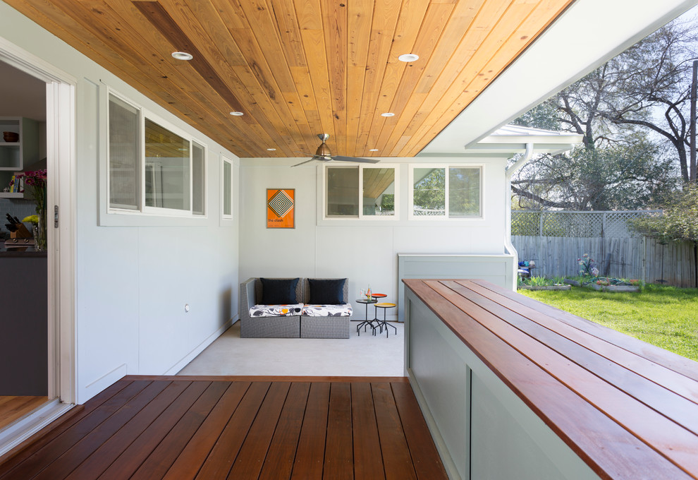 Trendy backyard deck photo in Austin with a roof extension