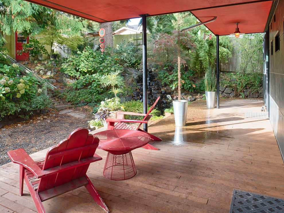 This is an example of a medium sized contemporary back terrace in Seattle with a water feature.