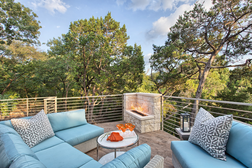 Example of a trendy deck design in Austin with a fire pit
