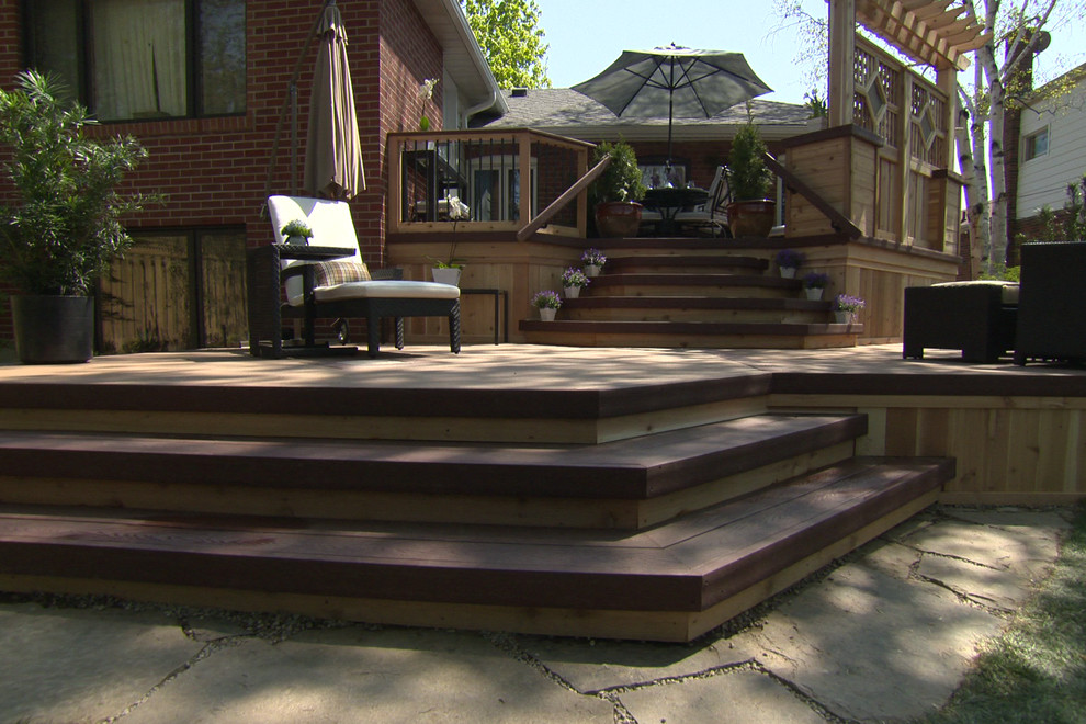 Example of a mid-sized classic backyard outdoor kitchen deck design in Toronto with no cover