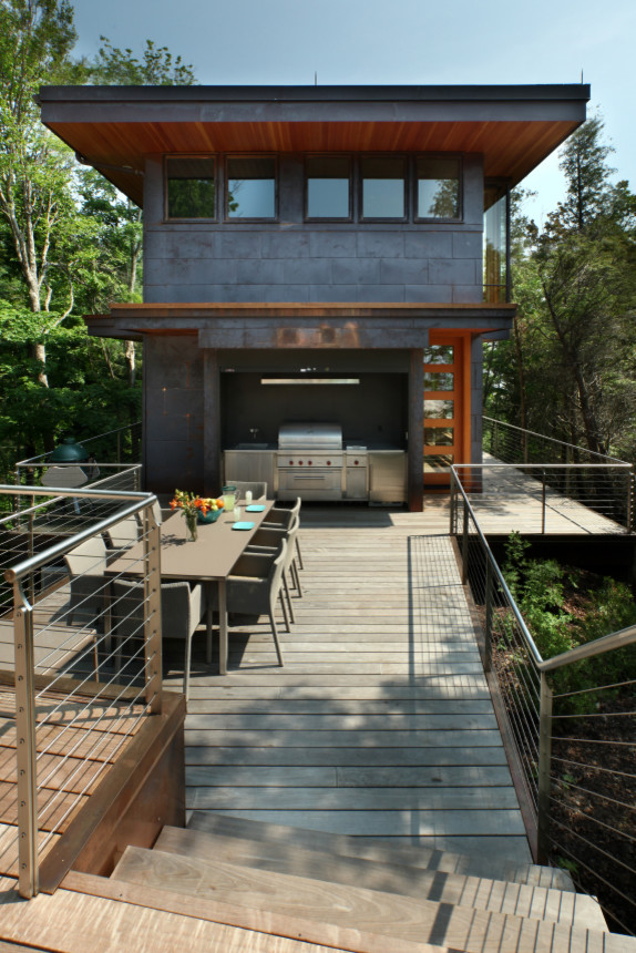 Inspiration pour une grande terrasse design avec une cuisine d'été et un auvent.