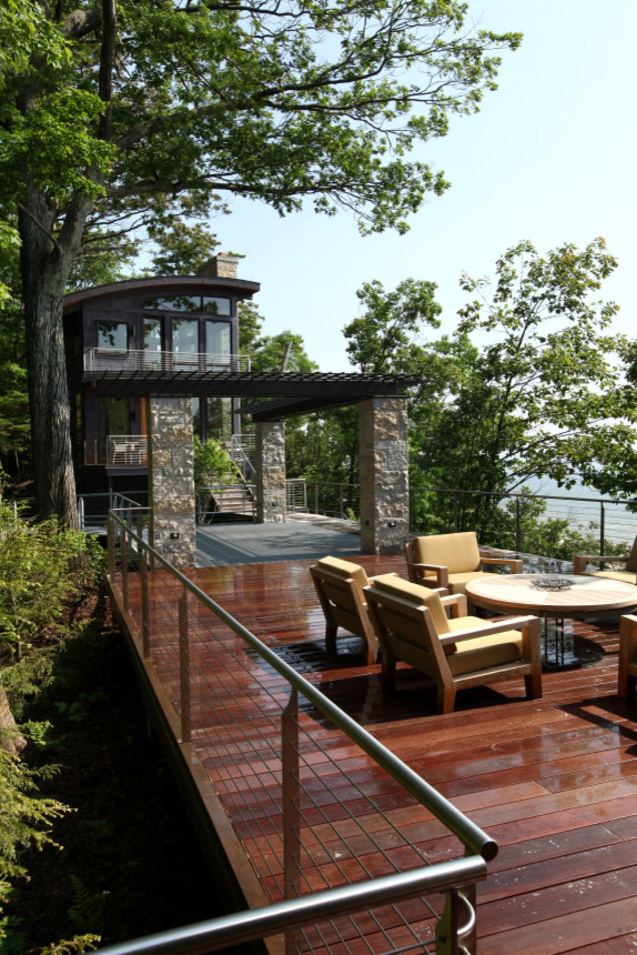 Inspiration for a large contemporary deck remodel in Grand Rapids with a pergola