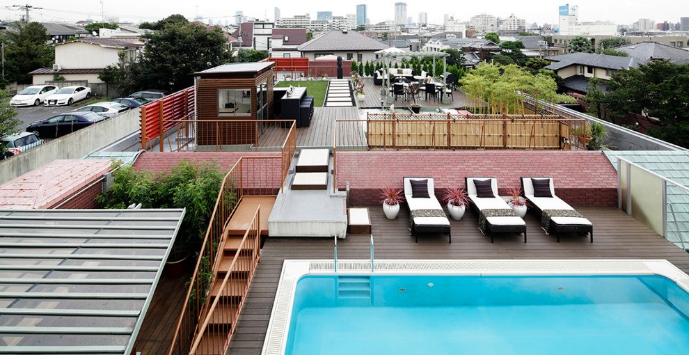 Large world-inspired roof terrace in Tokyo with a pergola.