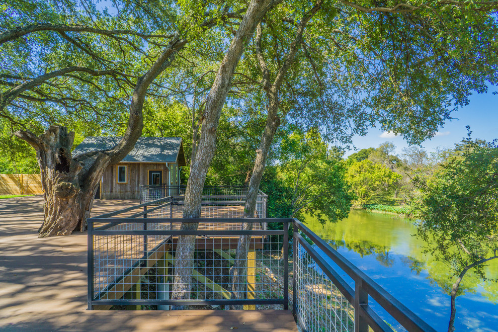 Deck - huge mid-century modern backyard deck idea in Austin